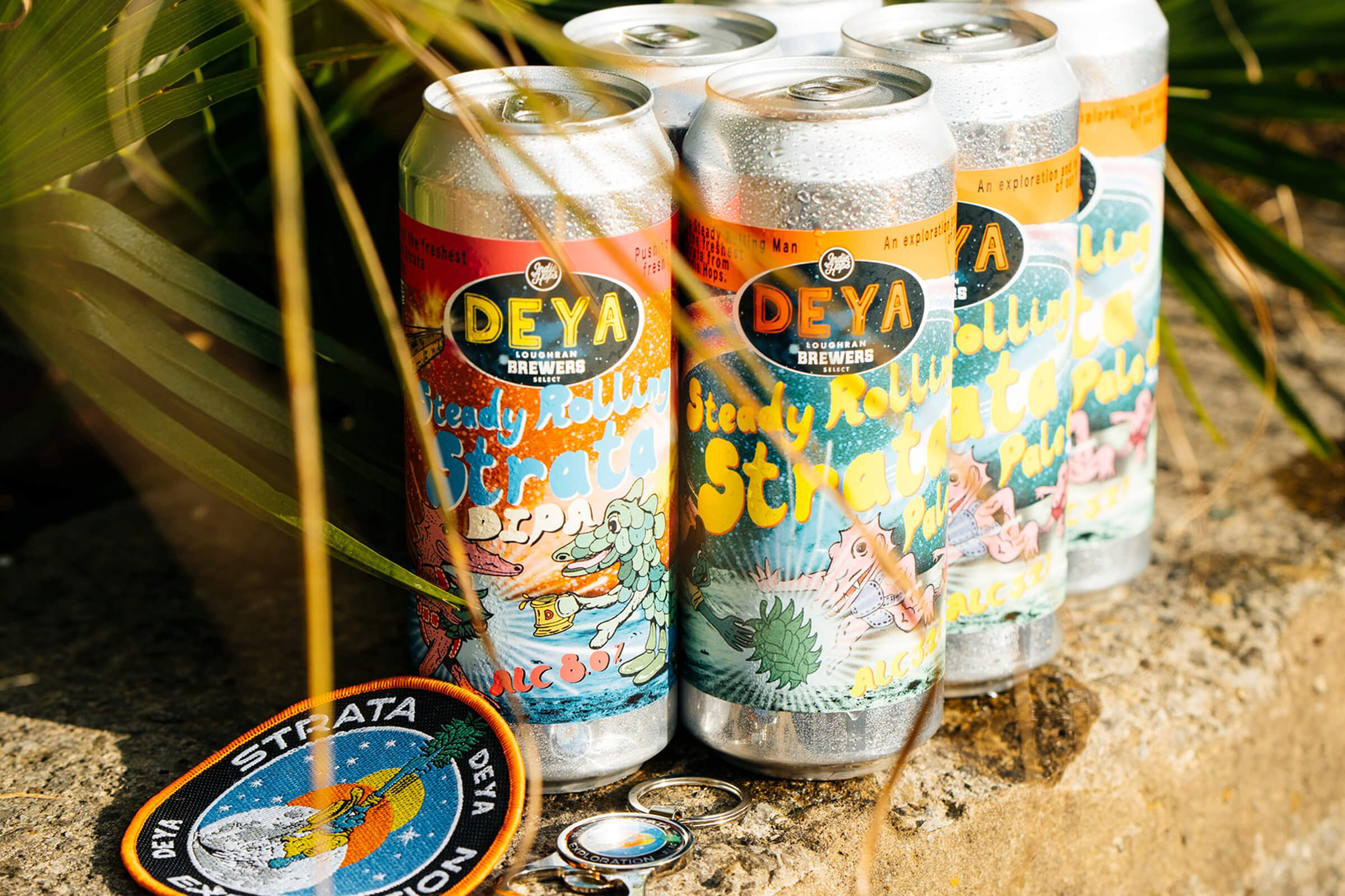 Cans of DEYA ‘Steady Rolling Strata’ Pale Ale & ‘Double Steady Rolling Strata’ DIPA with a merch patch & keyring commemorating the beer launch.